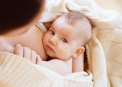 Mom holding baby after breastfeeding